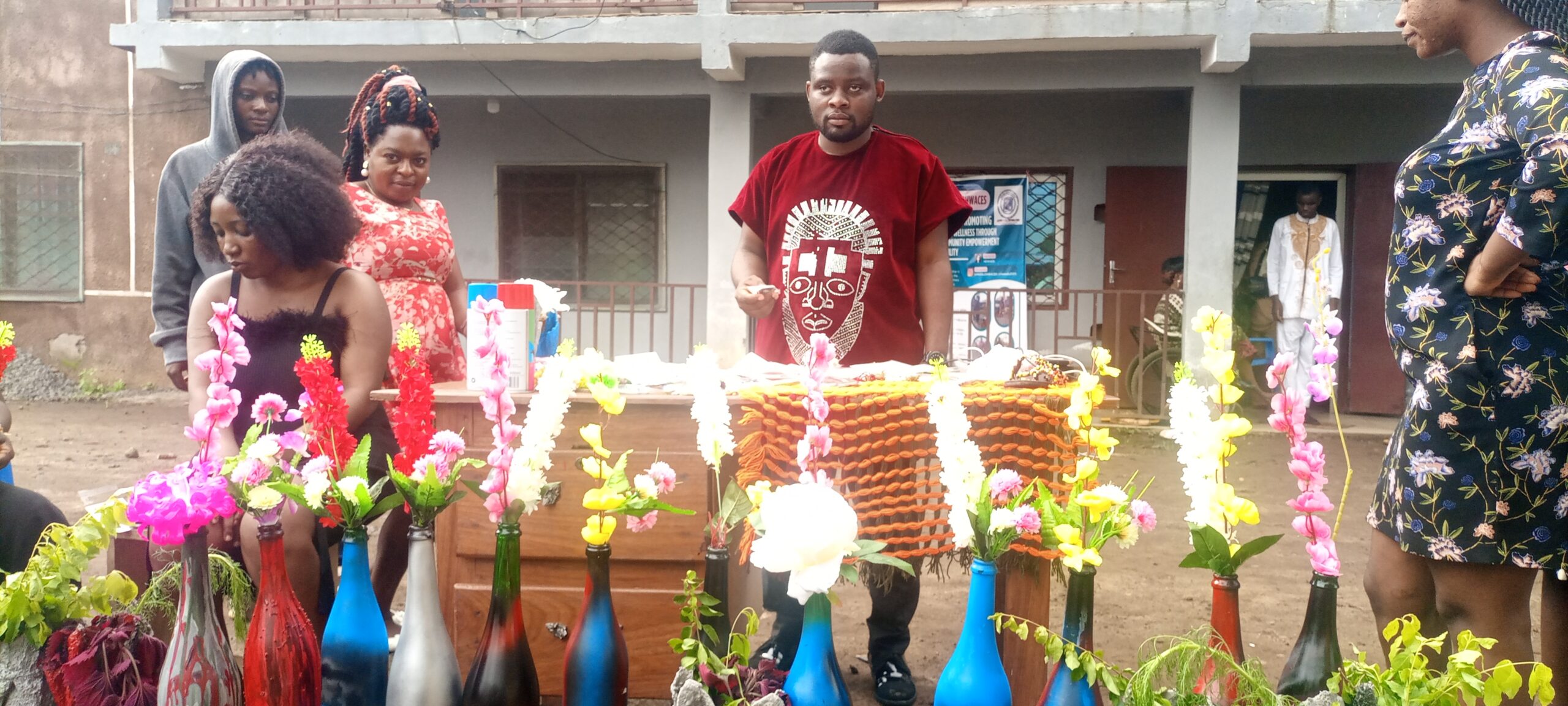 Kesah Princely holds a bead while other displayed items are in front of him