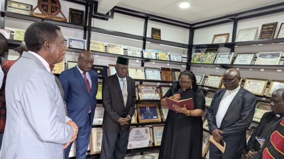 Sir, Dr., Barrister Ntumfor Nico Halle, clergy and others praying inside Award Gallery