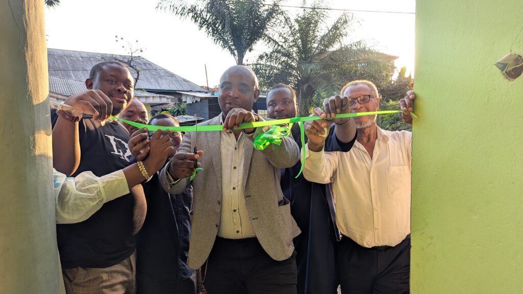 Cutting of the ribbon by Viban Jude (M) supported by Bouddih Adams(R) and Amindeh Blaise Atabong (L)