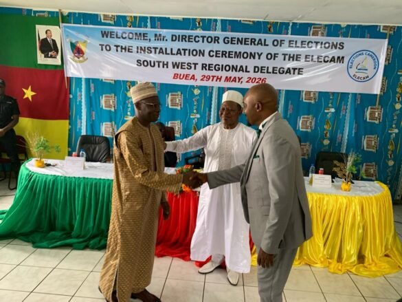 Incoming SW ELECAM (L) Abdoullahi Boboe in handshake with outgoing Delegate, (R) Zofoa Njoya Sake